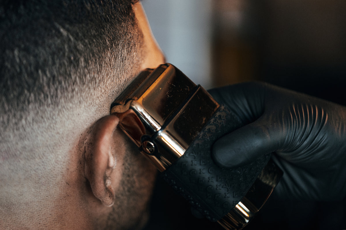 Barber working on a fade haircut